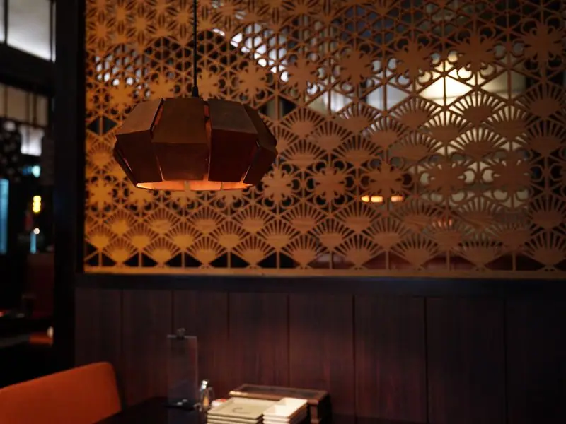 An intimate dining room lit by pendant lamps