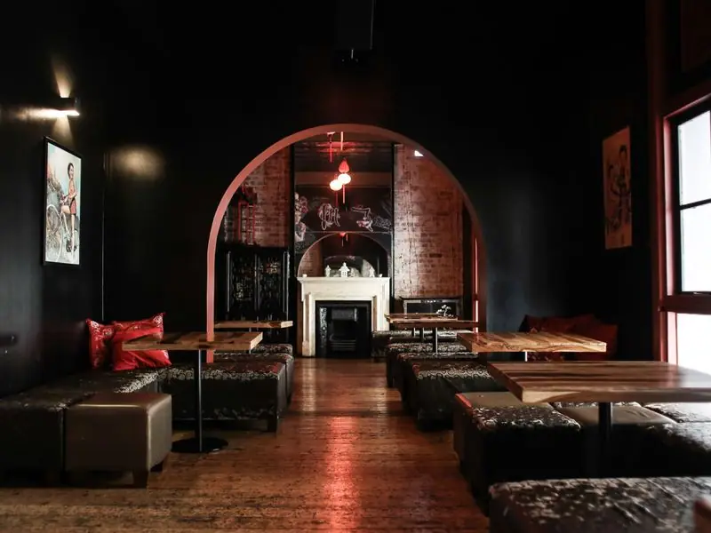 A low-lit lounge with leather seating and warm wood