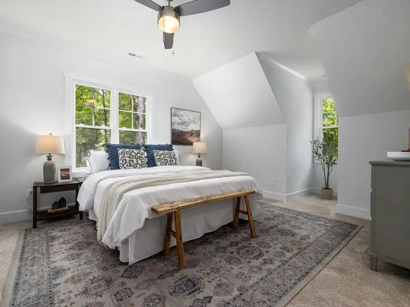 The Loft Suite with layered textiles and a velvet headboard